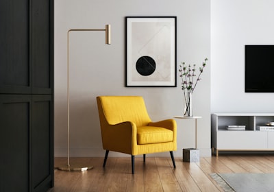 A yellow armchair set against a wall, facing into a bright living room