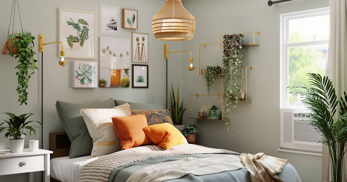 A small bedroom with a gallery wall of prints, hanging plants and orange bedding