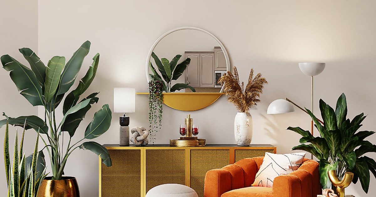 A living room filled with potted plants, an orange armchair and a gold sideboard under a round mirror